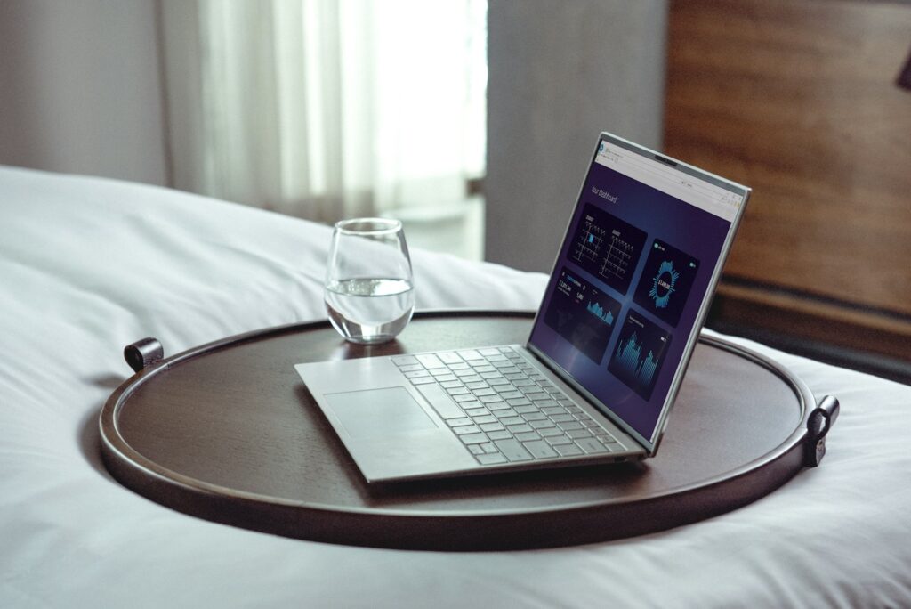 A laptop on a wooden table ready for online booking