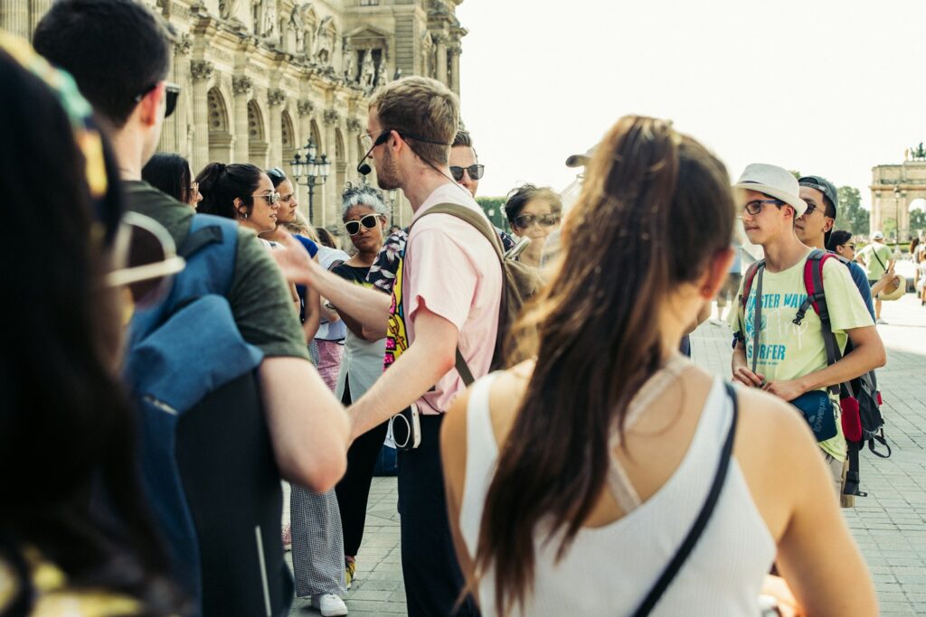 People walking along a historic street on a guided tour