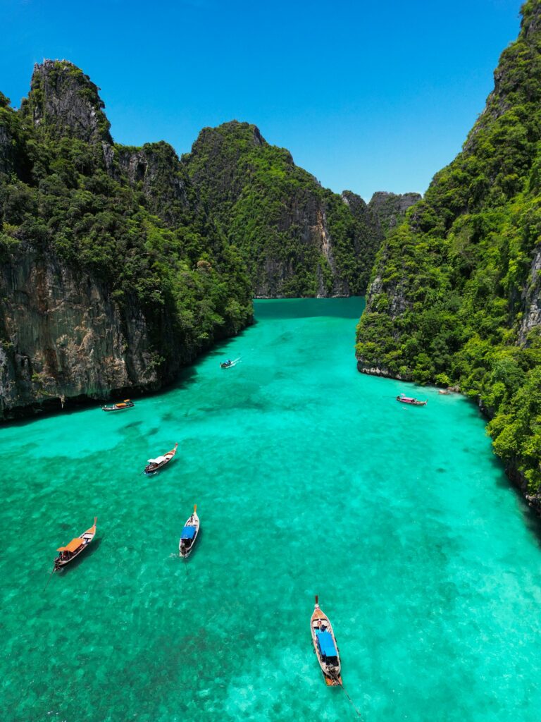 Longtail boats on the turquoise water of Pileh Lagoon, Phi Phi, Thailand